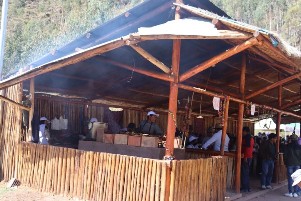 a group of people outside a wooden shelter